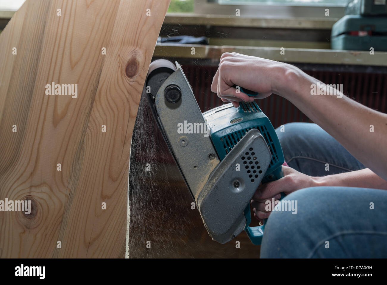 joiner grinds with belt sander - close-up Stock Photo