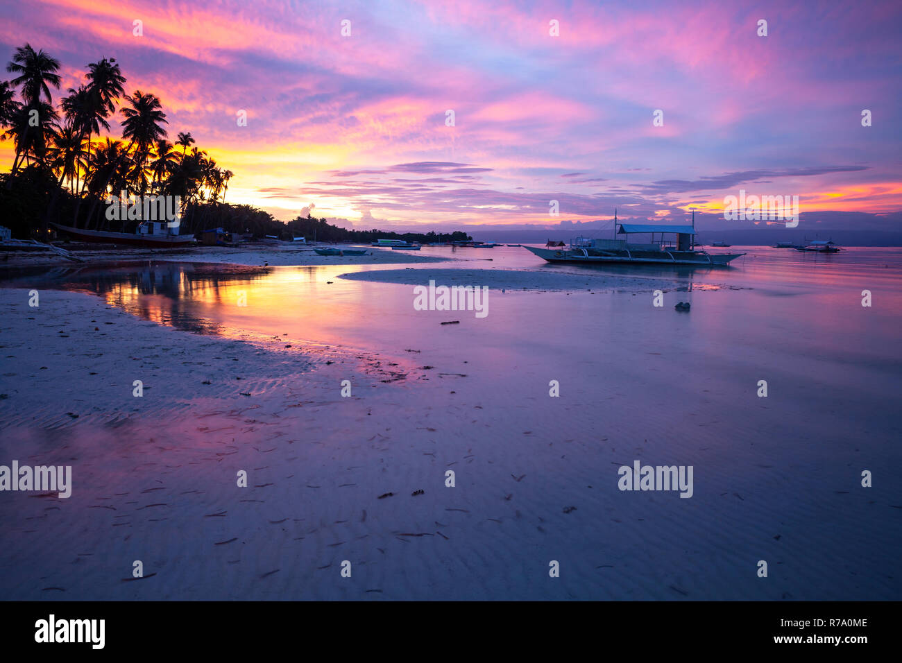 Stunning view of the sunset on the Philippine beach. Doljo beach, Panglao, Bohol, Philippines. Stock Photo