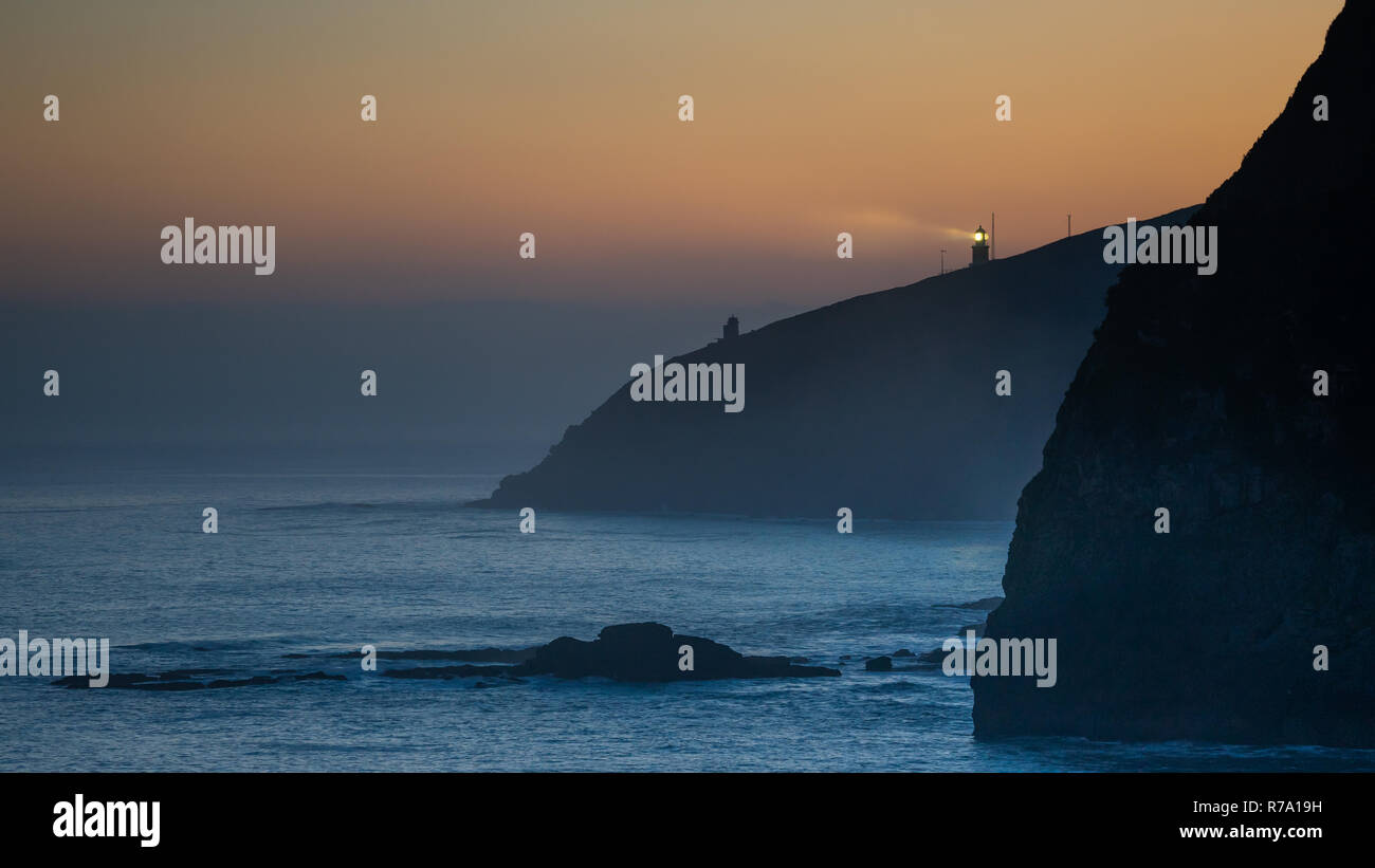 Matxitxako lighthouse ray of light at dawn, Basque Country Stock Photo