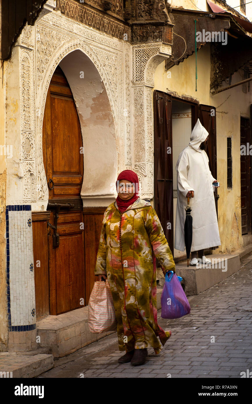 Morocco, Fes, Fes el Bali, Medina, Talaa Seghira, people passing entrance to Medersa Bou Inania Stock Photo
