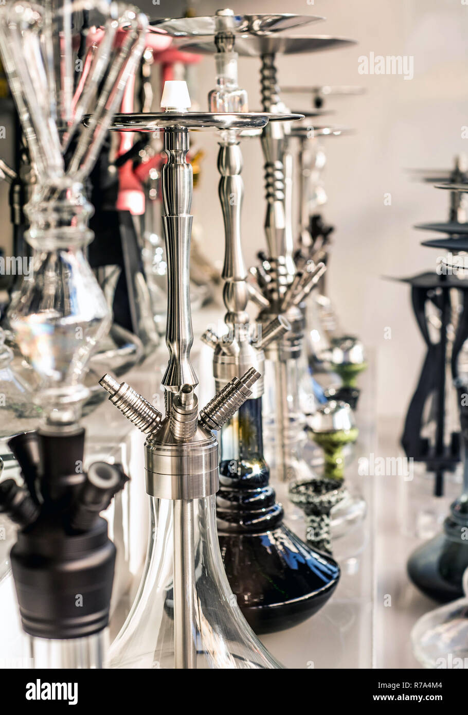 A lot of glass colorful hookahs shisha in a window shop smoking smoke