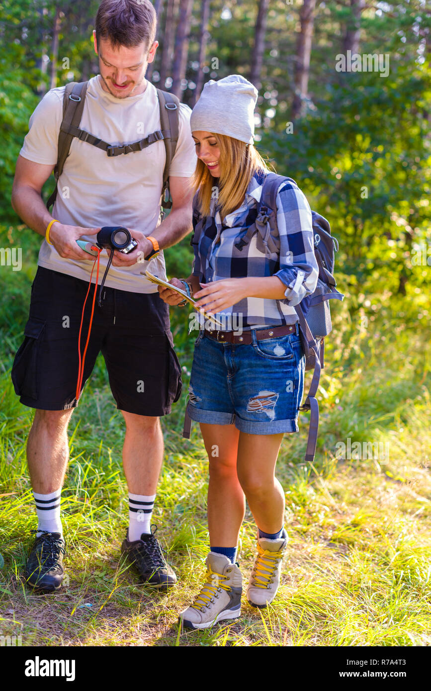 Couple map backpacking in sunny autumn mountain hi-res stock ...