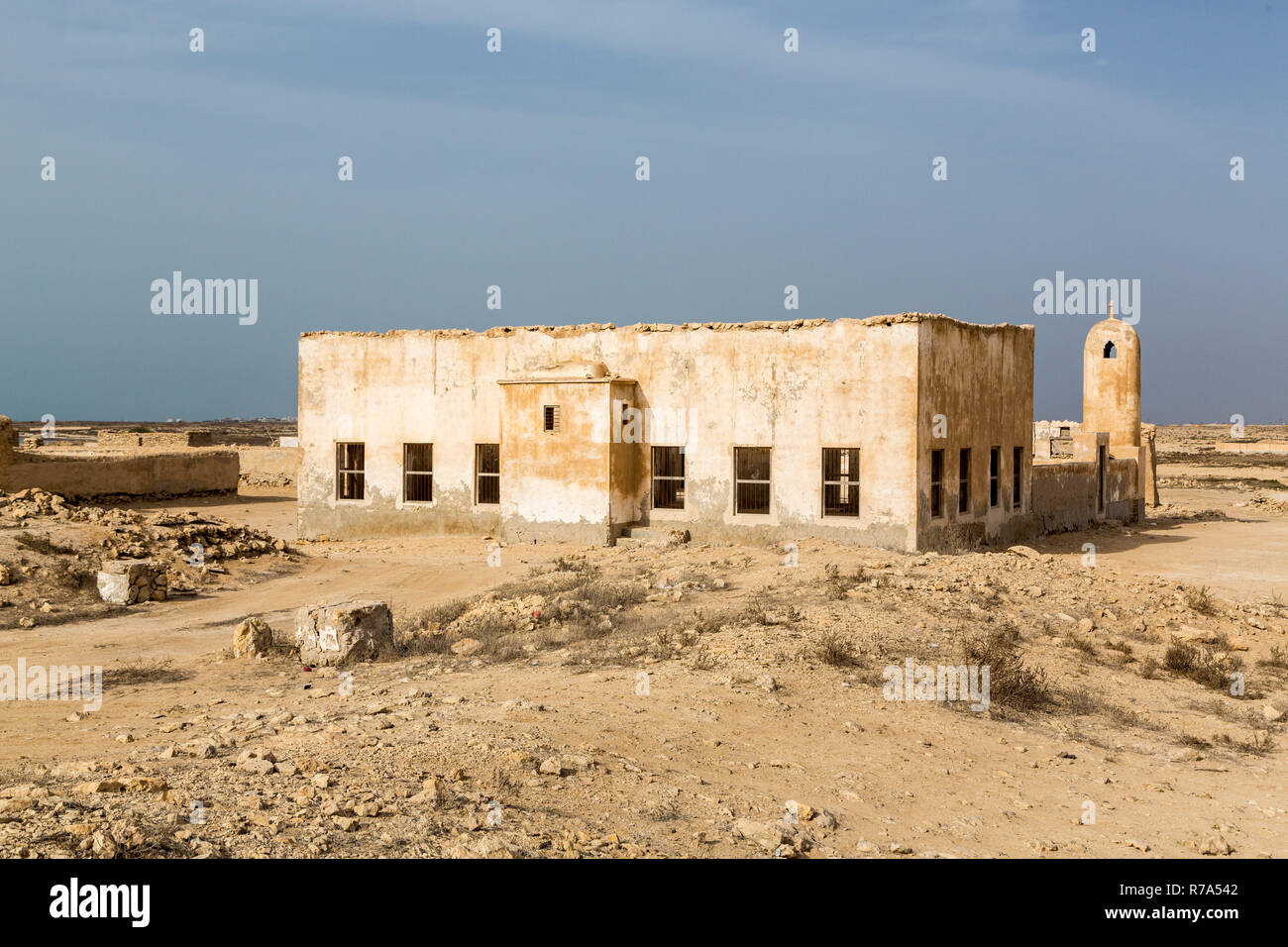 Ruined ancient old Arab pearling and fishing town Al Jumail, Qatar. The desert at coast of Persian Gulf. Minaret. Deserted village. Pile of stones Stock Photo