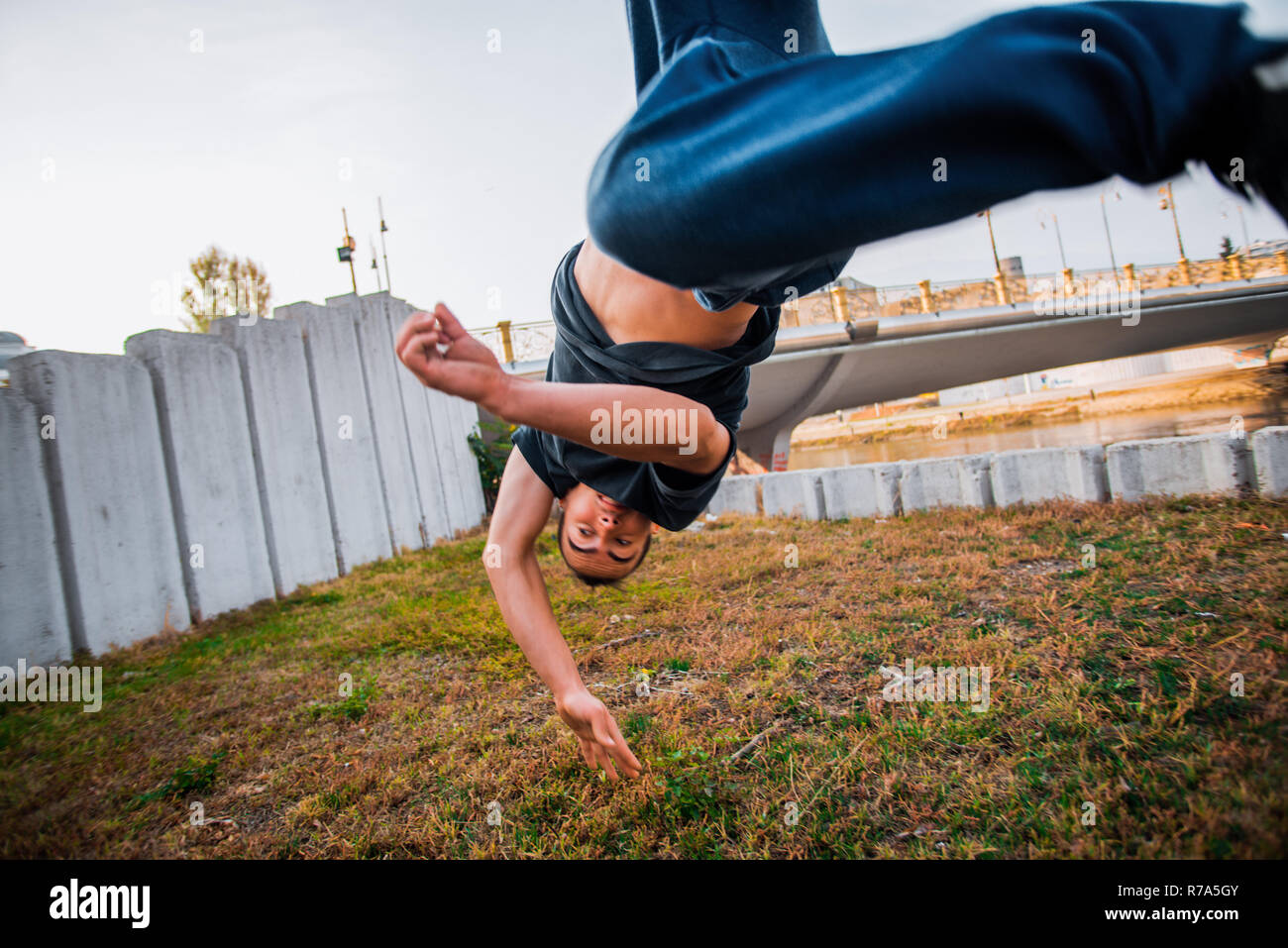 Young man practicing parkour while jumping in park Stock Photo
