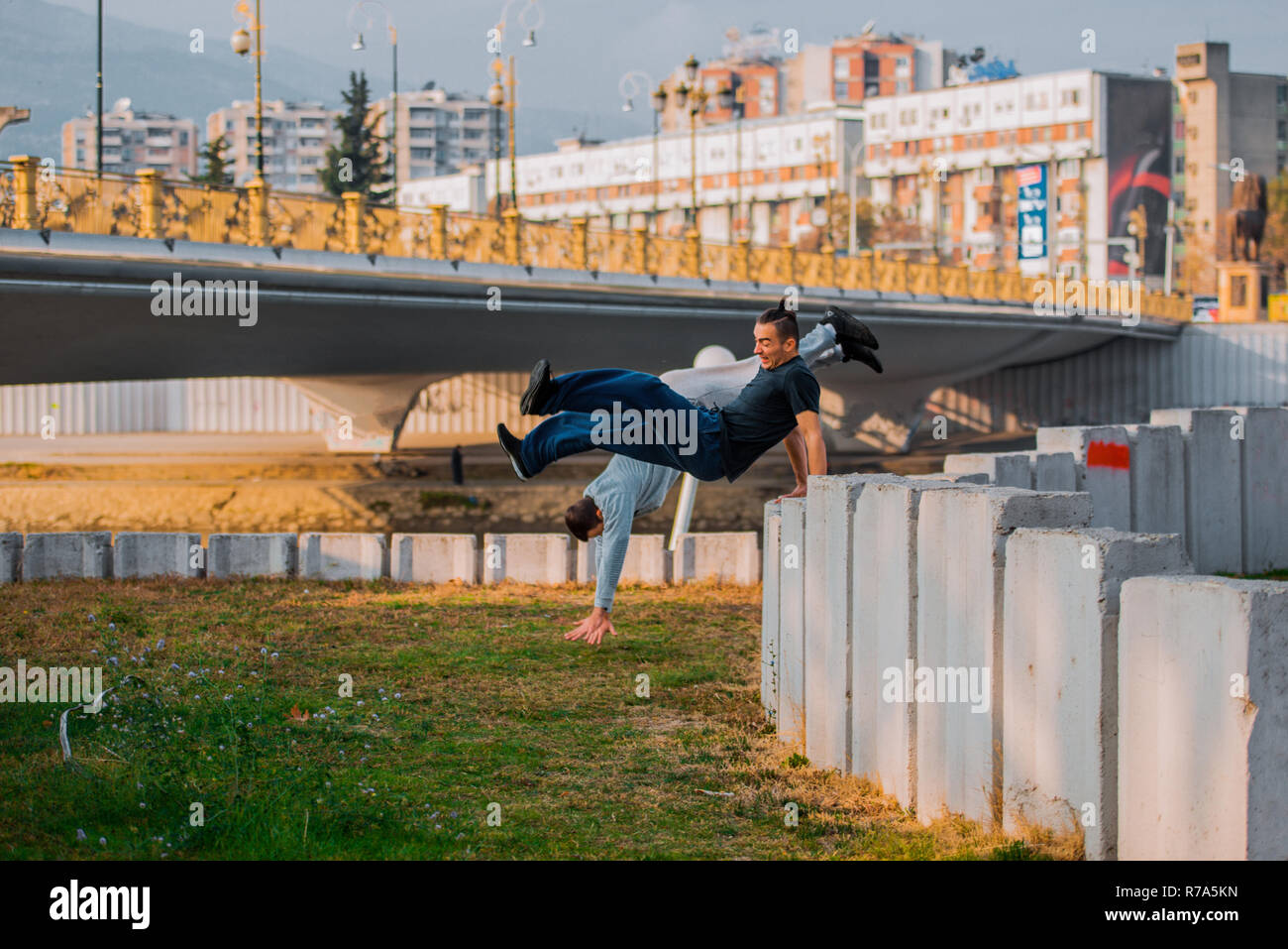 Two Stuntman Training Parkour While Jumping Over High Wall - 