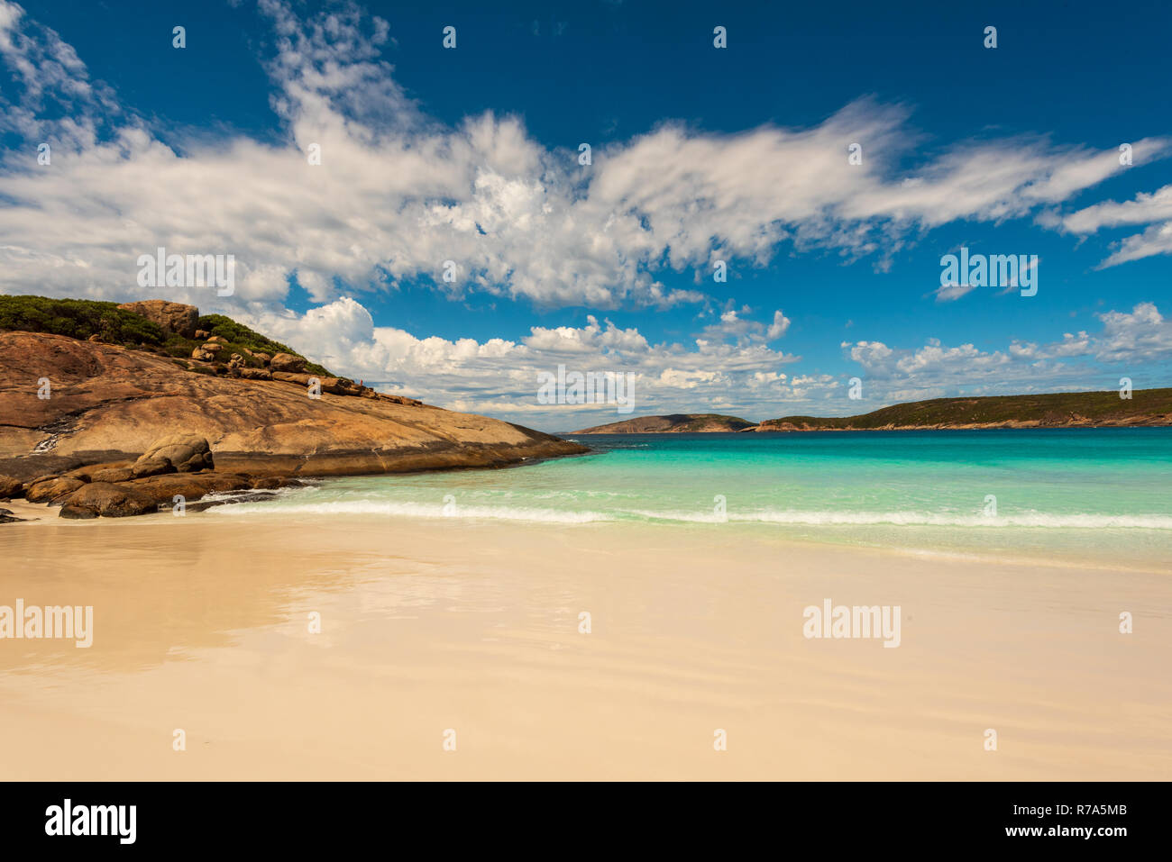 A wide-angle shot of the beach, rocks and blue sky of Hellfire Bay in Western Australia. Stock Photo