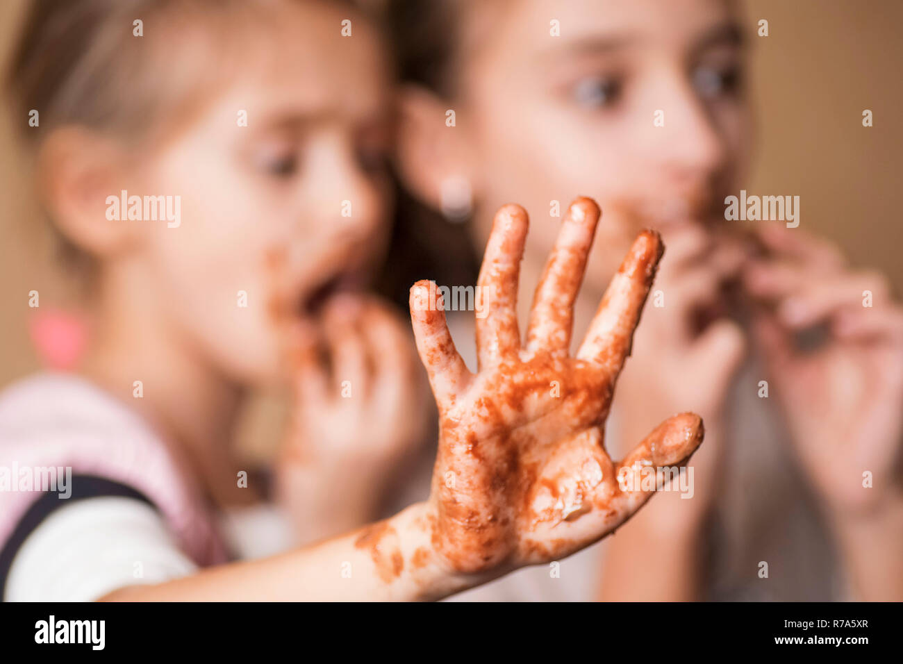 Girls, children eat chocolate, a mouth and hands of girls are smeared