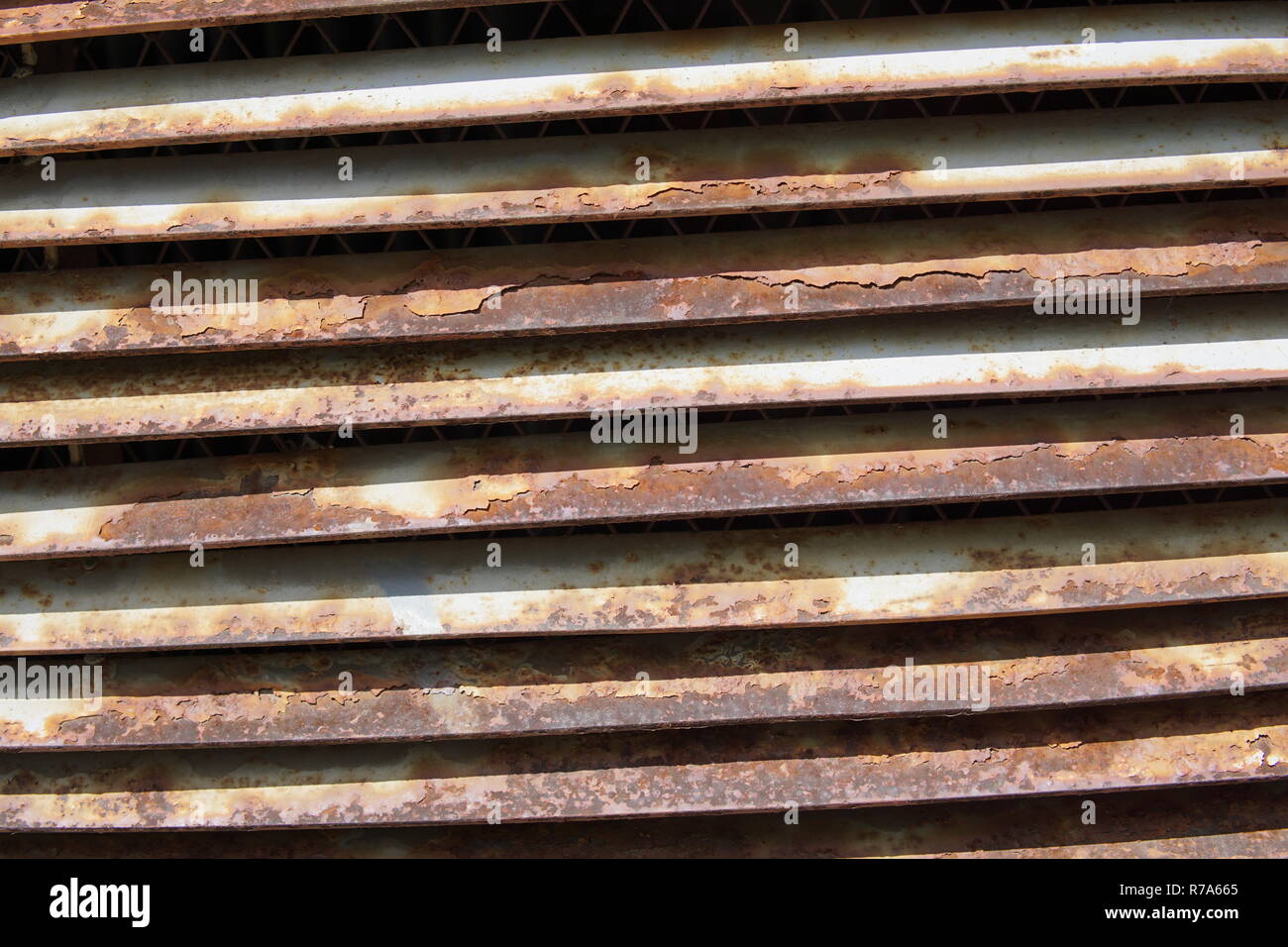 A brick wall with a rusty iron grille Stock Photo