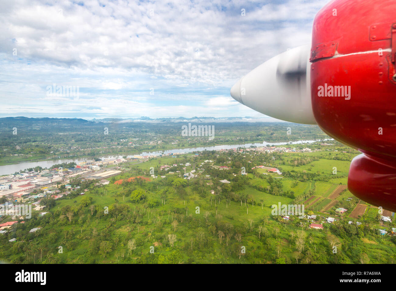 Air travel in Fiji, Melanesia, Oceania. View of Rewa river, Nausori town, Viti Levu island from a window of a small turboprop propeller airplane. Stock Photo