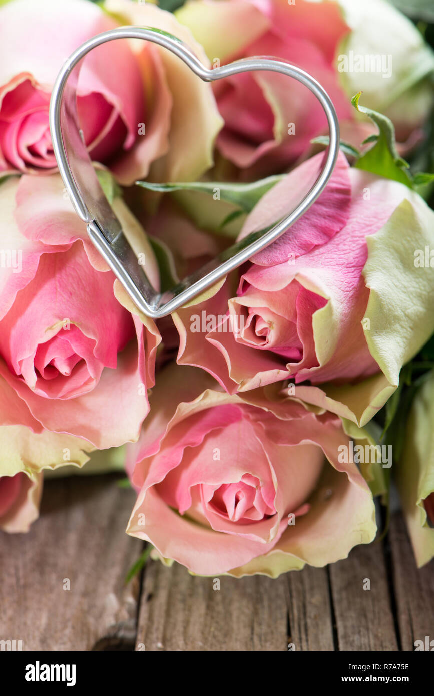 pink roses with a heart Stock Photo - Alamy