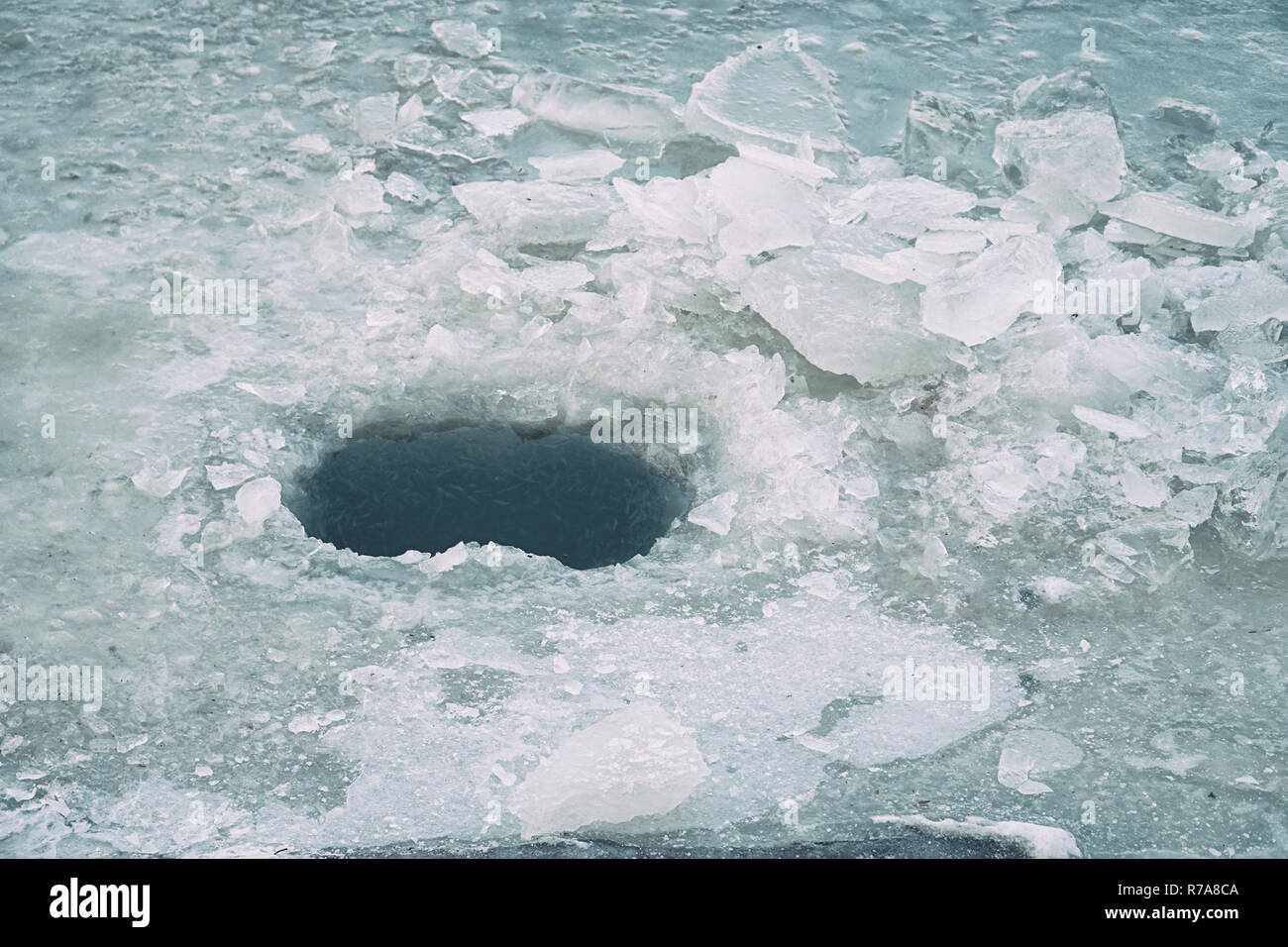 Ice hole in ice for winter fishing Stock Photo Alamy