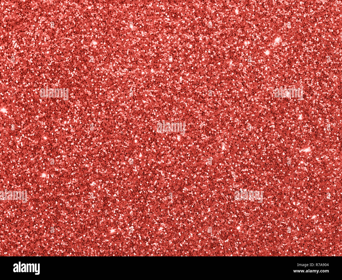 Sparkling background made of Living Coral 2019 lights. Festive blurred backdrop for holidays and parties. Top view or flat lay. Copy sace for text Stock Photo