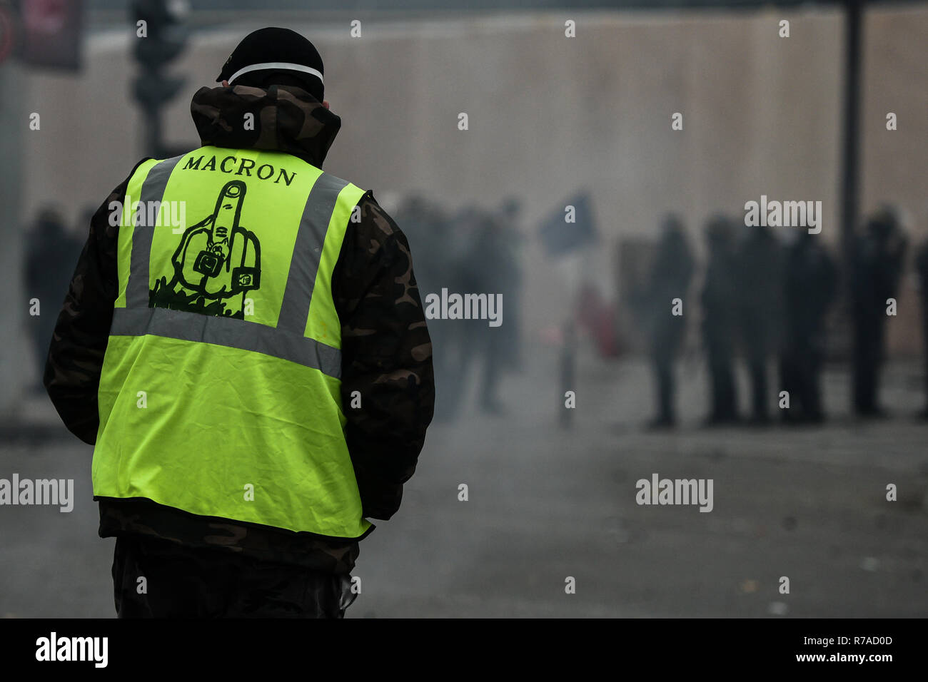 Paris, France. 8th December 2018. a protester looks on at the police during  a yellow vests (