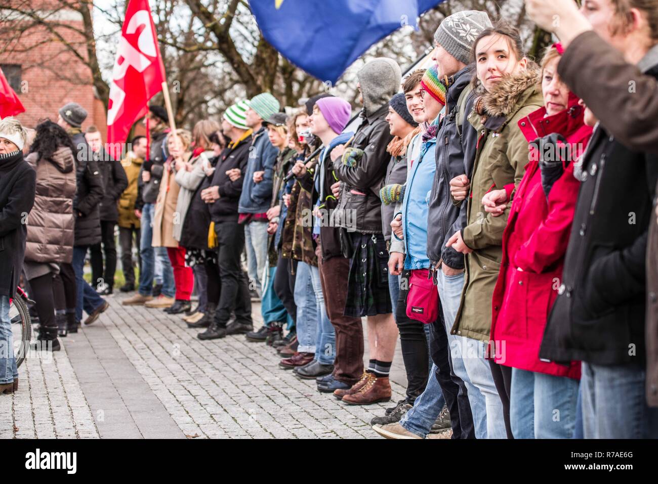 Munich, Bavaria, Germany. 8th December, 2018. Protestors against Pegida made a human chain. Pegida Dresden in Munich, the self-proclaimed original Pegida, organized a rally in the city's Milberthofen district in front of the Dankeskirche (Thanks Church) of Munich. Headed by Michael Stuerzenberger, the group rallied against the United Nations Migration Pact. Speaking with Stuerzenberger was Gernot Tegetmeyer fro Credit Credit: ZUMA Press, Inc./Alamy Live News Stock Photo