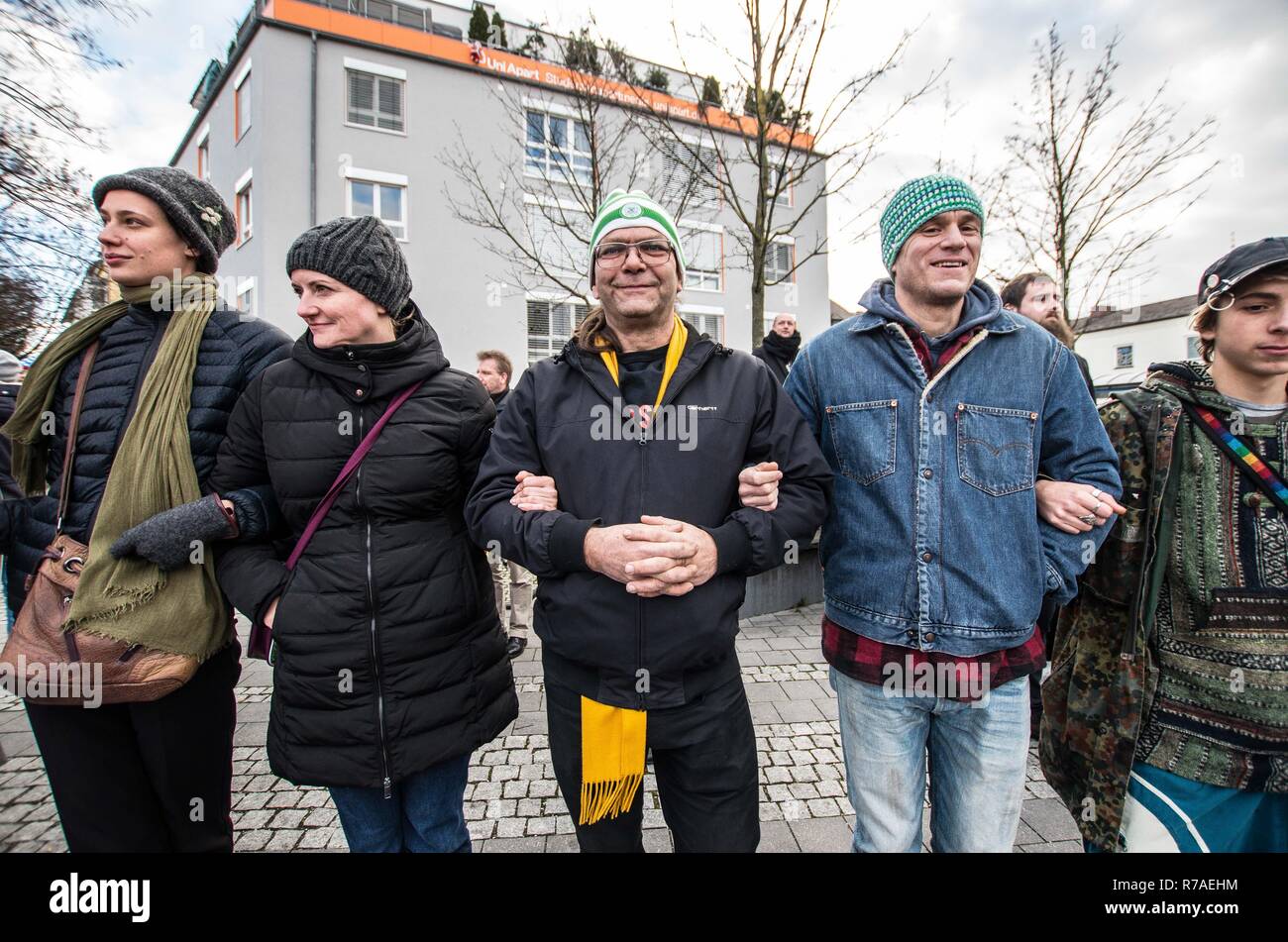 Munich, Bavaria, Germany. 8th December, 2018. Protestors against Pegida made a human chain. Pegida Dresden in Munich, the self-proclaimed original Pegida, organized a rally in the city's Milberthofen district in front of the Dankeskirche (Thanks Church) of Munich. Headed by Michael Stuerzenberger, the group rallied against the United Nations Migration Pact. Speaking with Stuerzenberger was Gernot Tegetmeyer fro Credit Credit: ZUMA Press, Inc./Alamy Live News Stock Photo