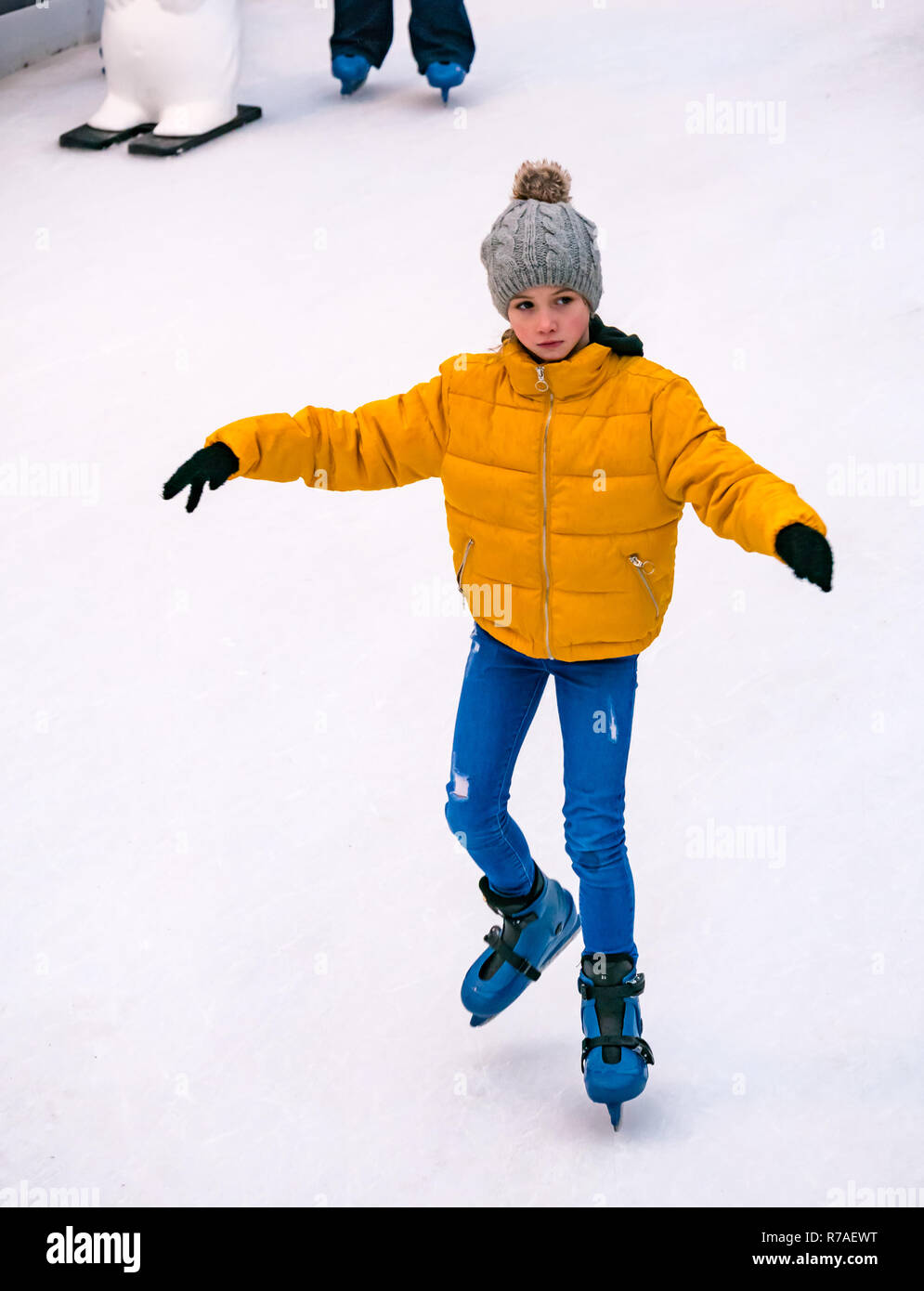 Edinburgh, Scotland, United Kingdom,  8th November 2018. Christmas celebrations: A busy Saturday in the capital city centre at Edinburghs Christmas celebration venue. A child skating keeping her balance at the ice rink in St Andrew Square Stock Photo