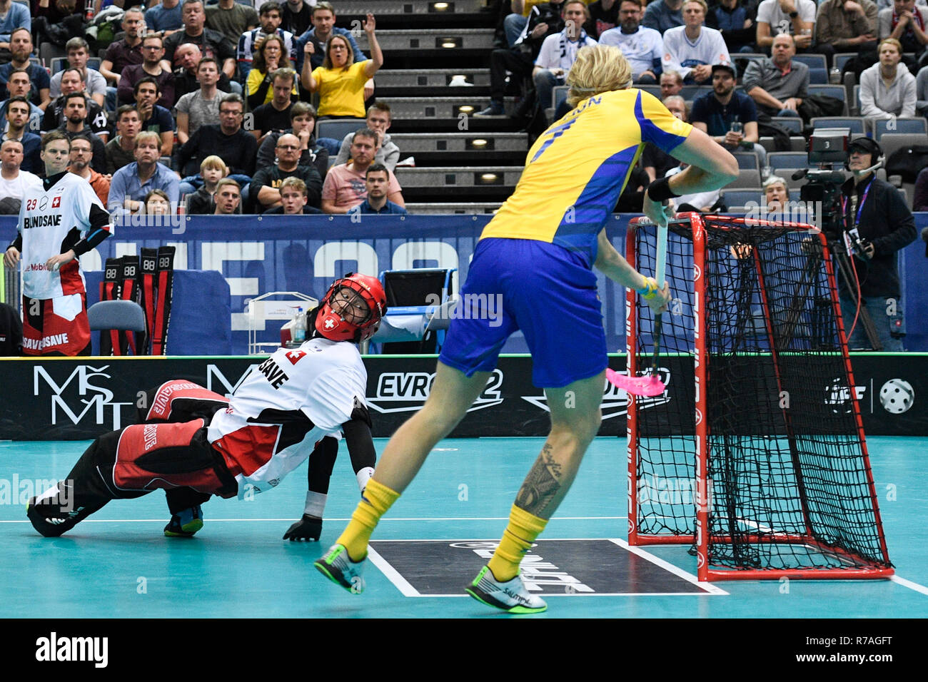 Prague, Czech Republic. 08th Dec, 2018. From right KIM NILSSON of Sweden  and goalie PASCAL MEIER of Switzerland in action during the Men's World  Floorball Championships match Switzerland vs Sweden, played in