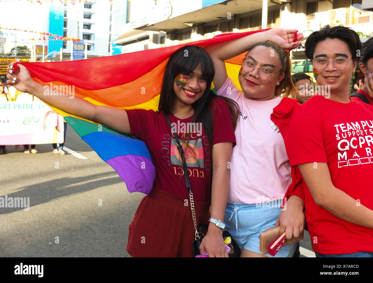 Quezon, Philippines. 8th Dec 2018. Members of the LGBT community seen posing for a picture  with their rainbow flag during the Pride march. The Quezon City Government and the QC Pride Council host again the LGBT Pride March. It's aim is to campaign for HIV ang AIDS prevention and human rights. Credit: SOPA Images Limited/Alamy Live News Stock Photo
