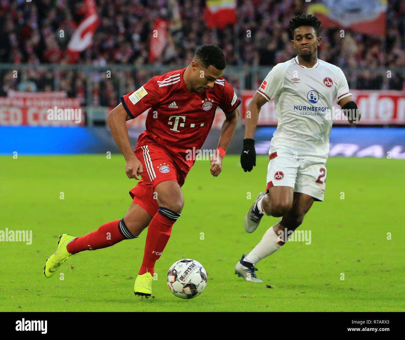 Munich, Germany. 8th Dec, 2018. Bayern Munich's Serge Gnabry (L) breaks through during a German Bundesliga match between Bayern Munich and 1.FC Nuremberg in Munich, Germany, on Dec. 8, 2018. Bayern Munich won 3-0. Credit: Philippe Ruiz/Xinhua/Alamy Live News Stock Photo