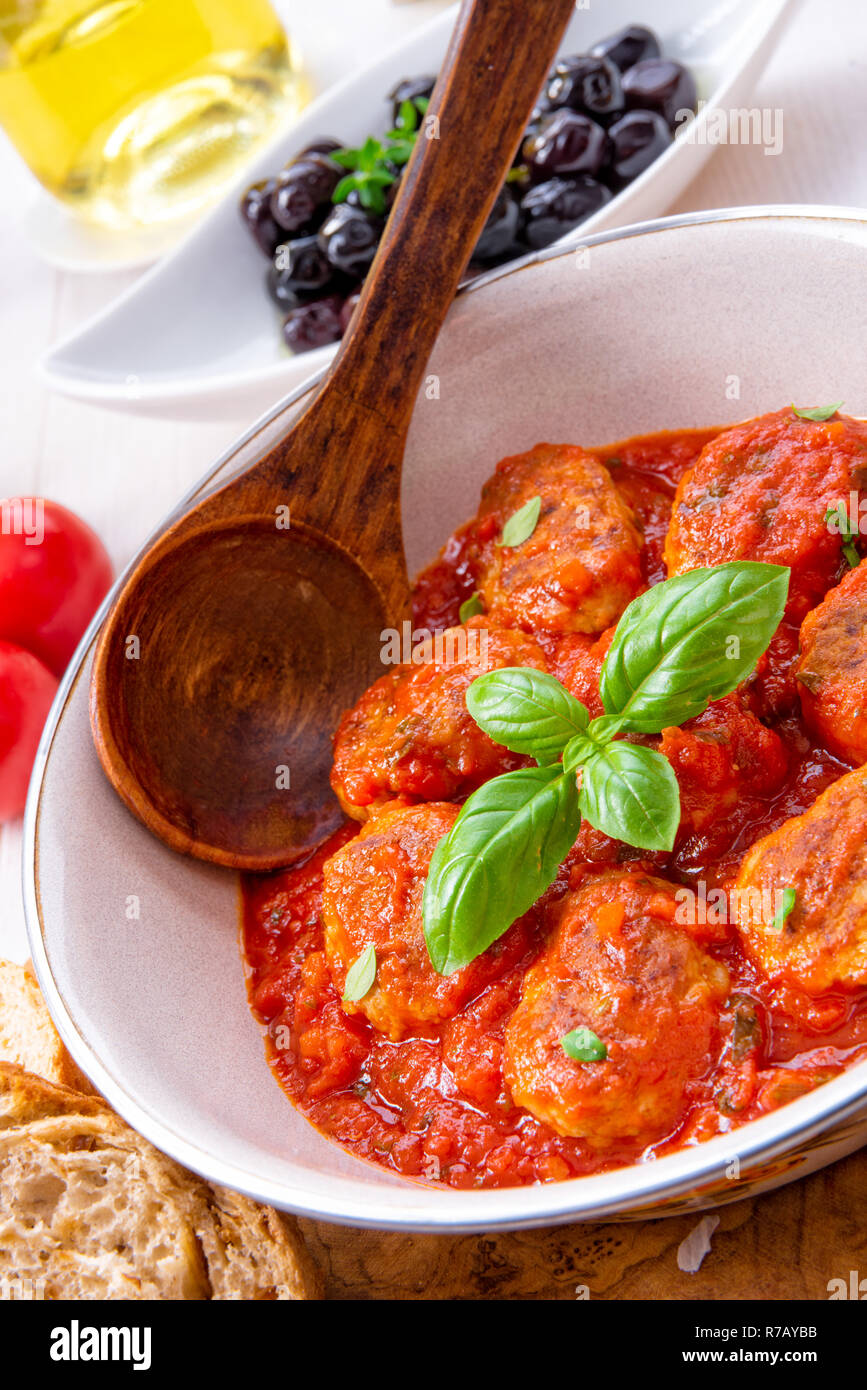 baked mini meatballs in tomato sauce with basil Stock Photo Alamy