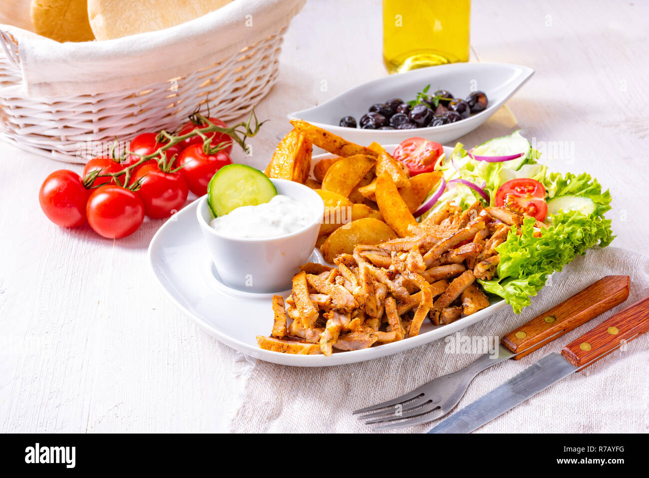 gyros plate with green salad,olives and potato wedges Stock Photo Alamy