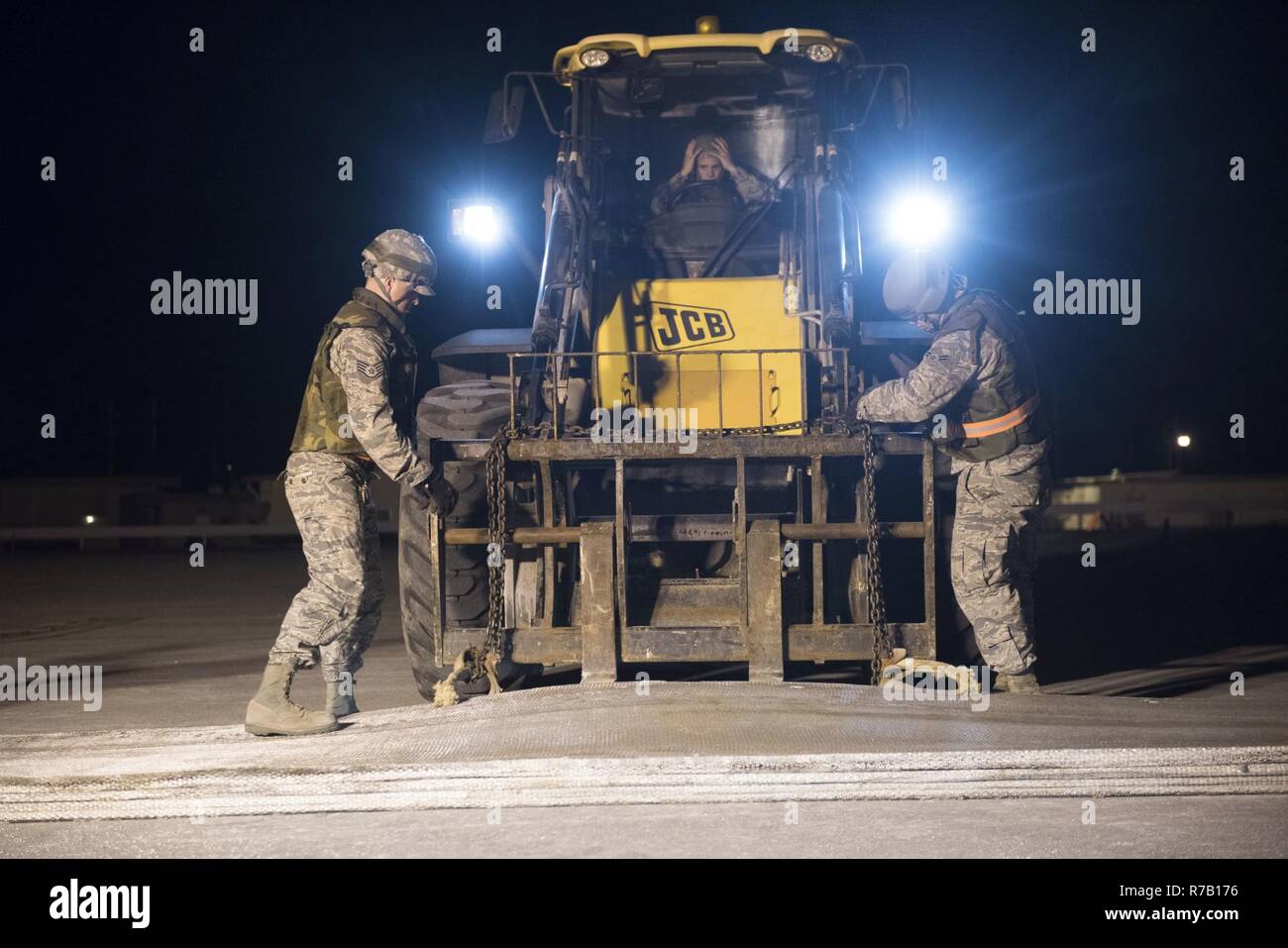 U.S. Air Force Airmen from the 18th Civil Engineer Squadron chain a ...
