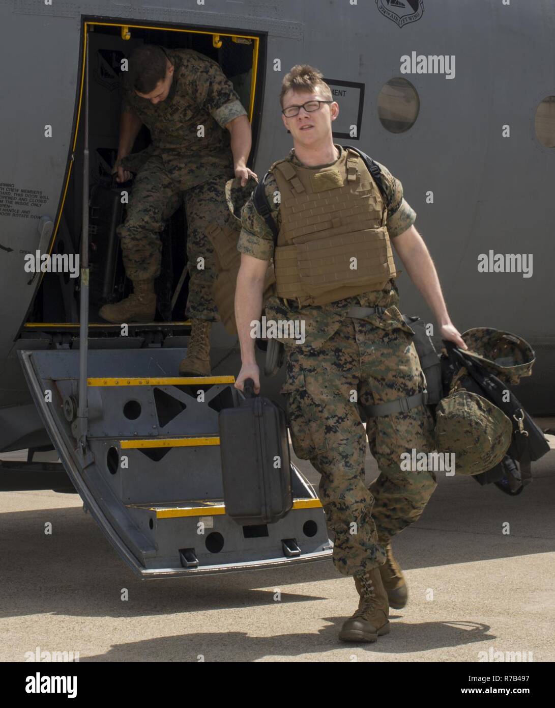 U.S. Marine Corps Lance Cpl. Jeffrey Tschirhart, an aviation operations specialist with Marine Attack Squadron (VMA) 311, and Sgt. Albert Ludwig, a nondestructive inspection technician with Marine Aviation Marine Aviation Logistics Squadron (MALS) 12, arrive at Kunsan Air Base, Republic of Korea, April 12, 2017. MALS 12 and VMA 311 are participating in Exercise MAX THUNDER 17, an operational readiness exercise built to promote interoperability between U.S. and ROK forces. This annual exercise helps to promote stability in the Asia-Pacific region. Stock Photo