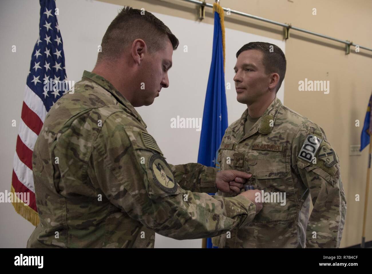 Maj. Michael Warren, 824th Base Defense Squadron commander, pins an achievement medal on Staff Sgt. David Green, 824th BDS fireteam leader, April 10, 2017, at Moody Air Force Base, Ga. Green received the medal for his act of heroism when he helped a trapped victim during an off-base vehicle incident. Stock Photo