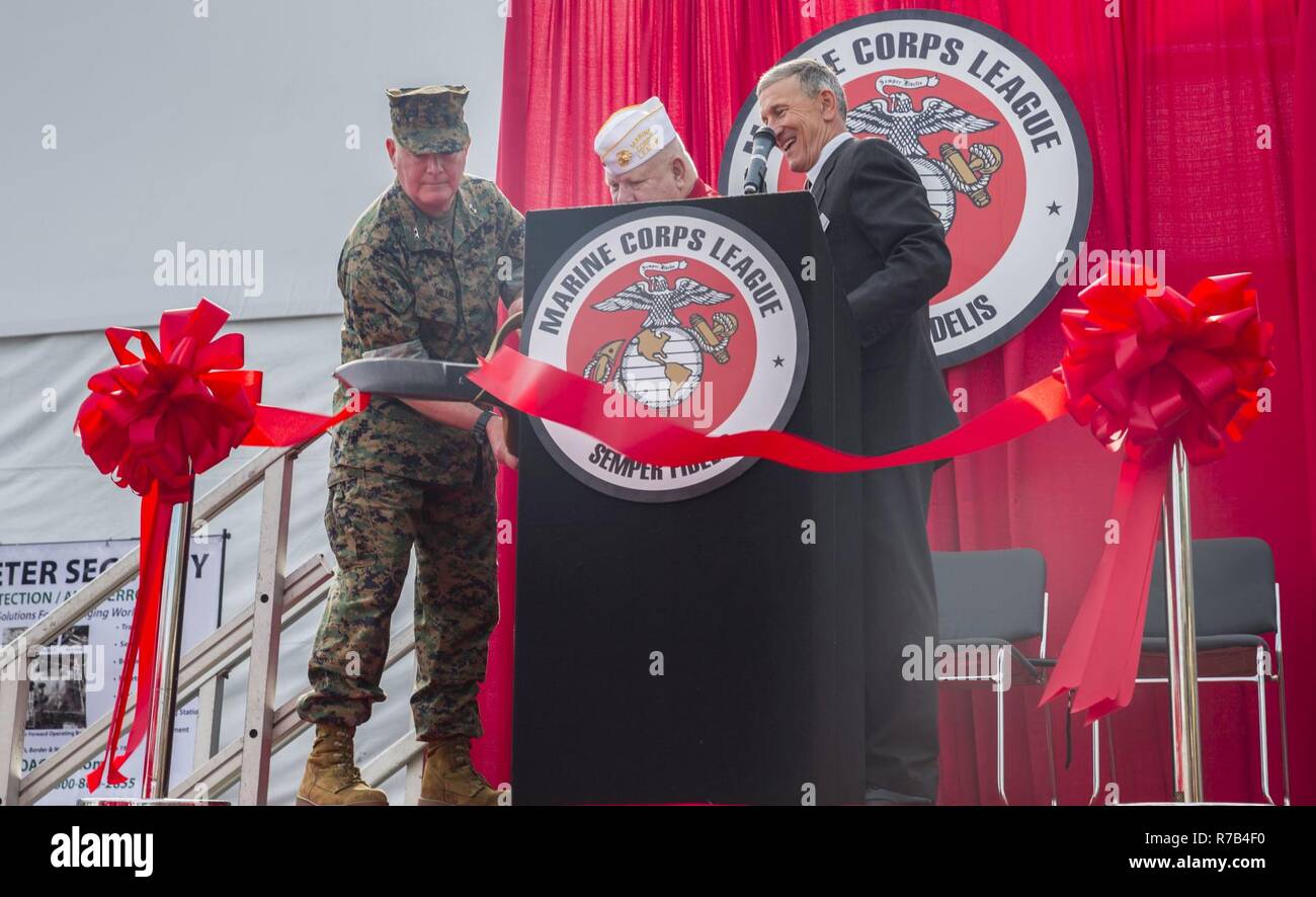 U.S. Marine Corps Maj. Gen. Walter L. Miller Jr., left, commanding general, II Marine Expeditionary Force, Richard D. Gore Sr., center, commandant, Marine Corps League, and retired Maj. Gen. Michael Regner, staff director, Headquarters Marine Corps, cut the ribbon at the opening ceremony for the Marine South Military Exposition, Goettege Field House, Camp Lejeune N.C., April 13, 2017. The Marine South Exposition is sponsored by the Marine Corps League and is a forum for defense contractors to display, inform, and promote the latest in defense equipment and technology. Stock Photo