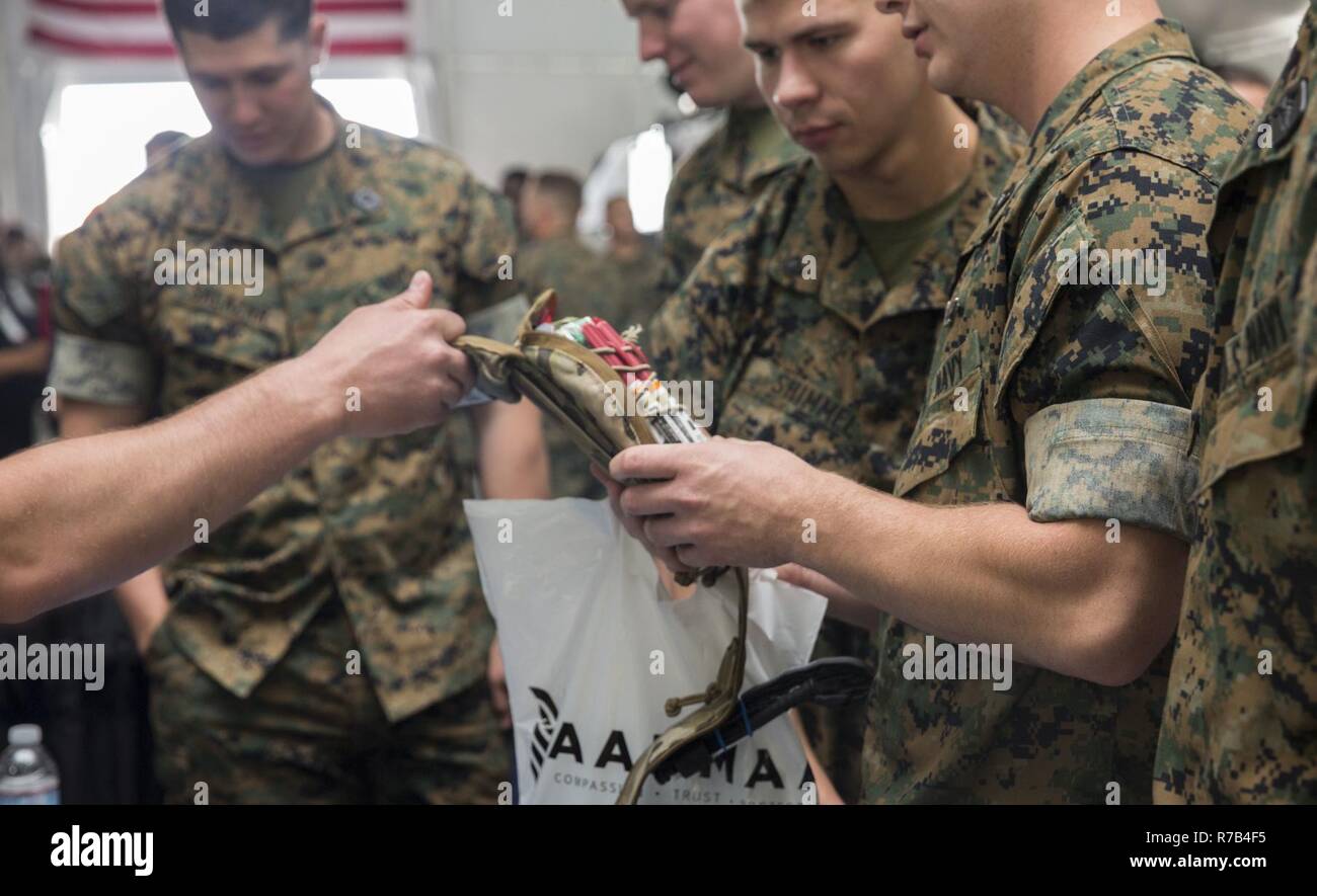 U.S. Marines and Sailors familiarize themselves with new first aid kits during the Marine South Military Exposition, Goettege Field House, Camp Lejeune N.C., April 13, 2017. The Marine South Exposition is sponsored by the Marine Corps League and is a forum for defense contractors to display, inform, and promote the latest in defense equipment and technology. Stock Photo