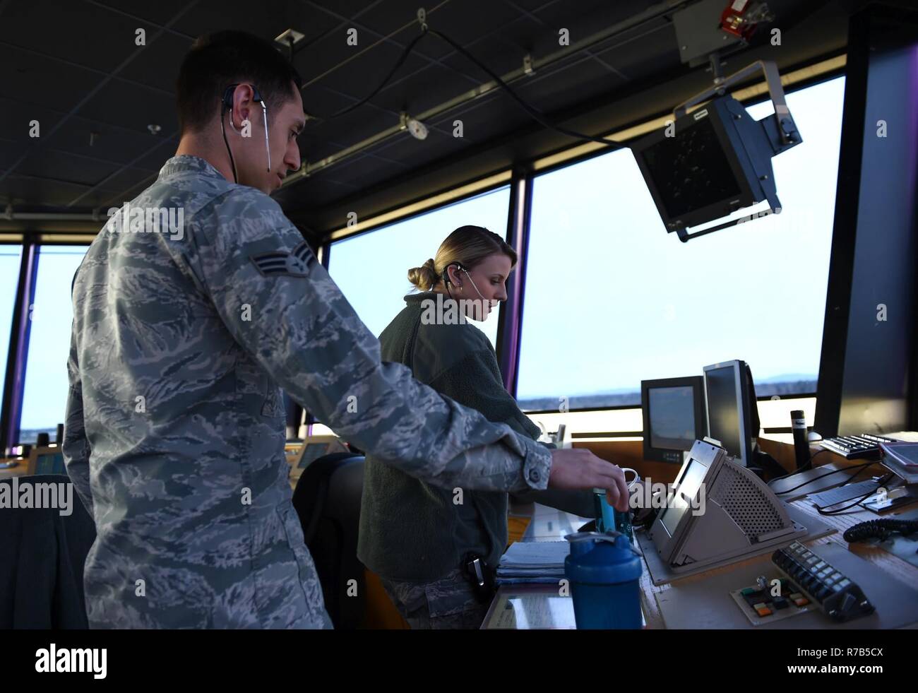 Senior Airman Nicholas Magliacane and Airman 1st Class Courtney Gomez, 62nd Operations Support Squadron Air Traffic Controllers, work to de-conflict air traffic at the McChord Field flight line on April 11, 2017, on Joint Base Lewis-McChord, Wash. The 62nd OSS tower at McChord responded quickly to prevent an aircraft incident April 11, 2017, on the McChord runway, when an U.S. Navy P-3 Orion seemingly lost all radio communications with them. Stock Photo