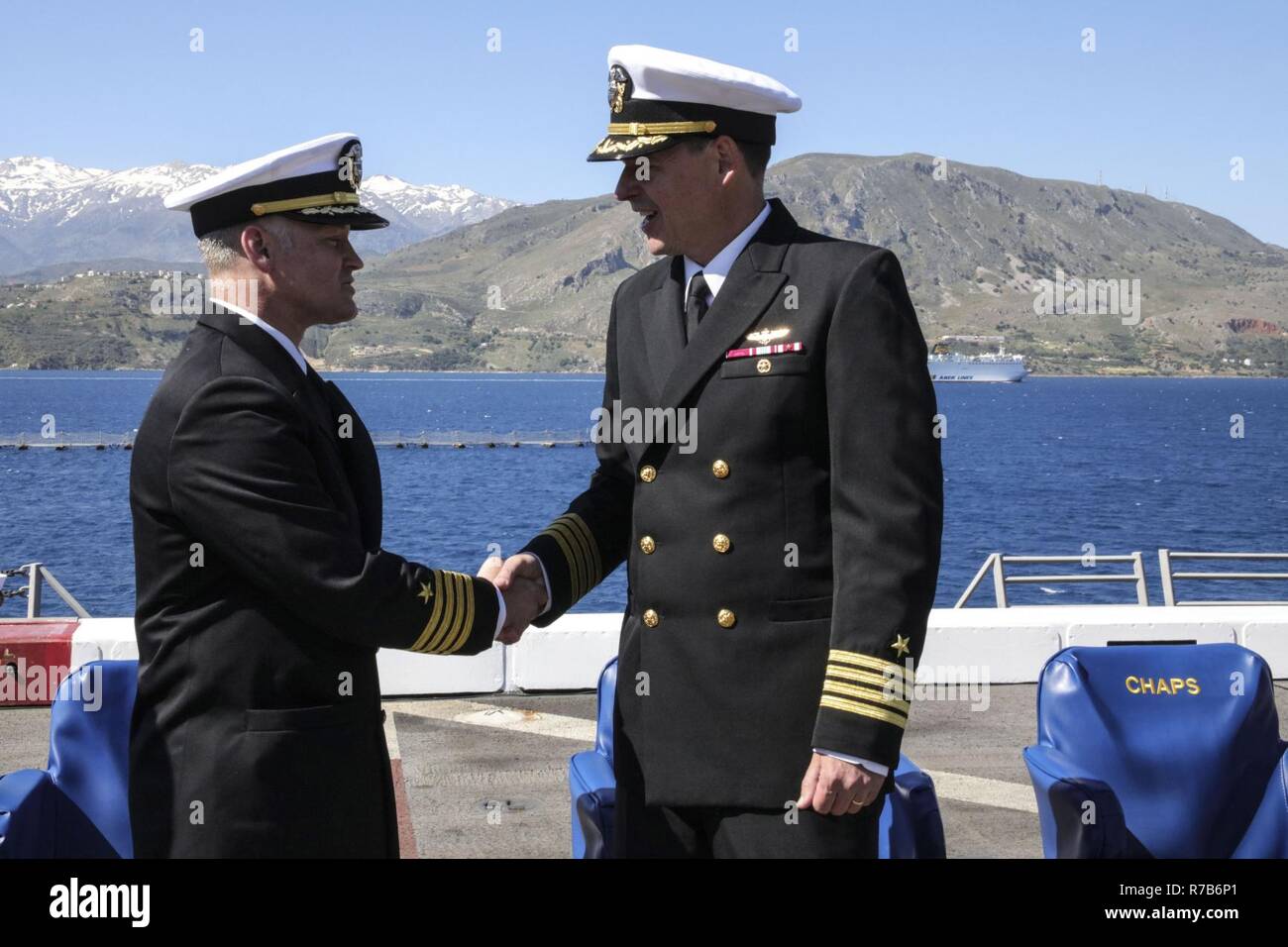 SOUDA BAY, Greece (May 5, 2017) Capt. Randall Peck , left, congratulates Capt. Maximilian Clark after being relieved as commanding officer of the San Antonio-class amphibious transport dock ship USS Mesa Verde's (LPD 19) during a change of command ceremony May 5, 2017. The ship is deployed with the Bataan Amphibious Ready Group to support maritime security operations and theater security cooperation efforts in the U.S. 6th Fleet area of operations. Stock Photo