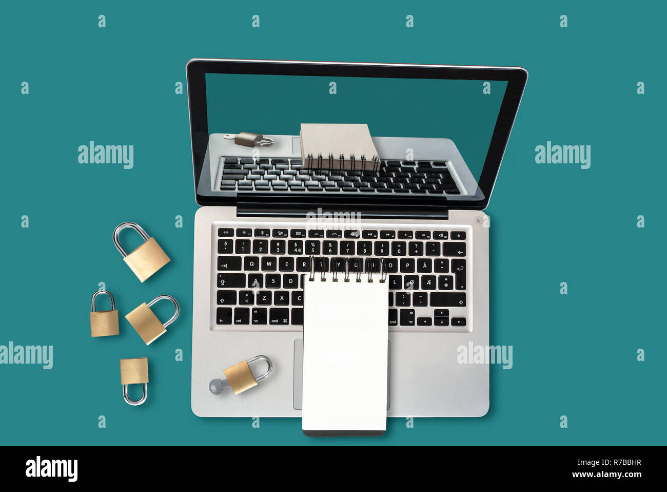 Top view of a laptop, padlocks and a notepad with copyspace, a security concept Stock Photo