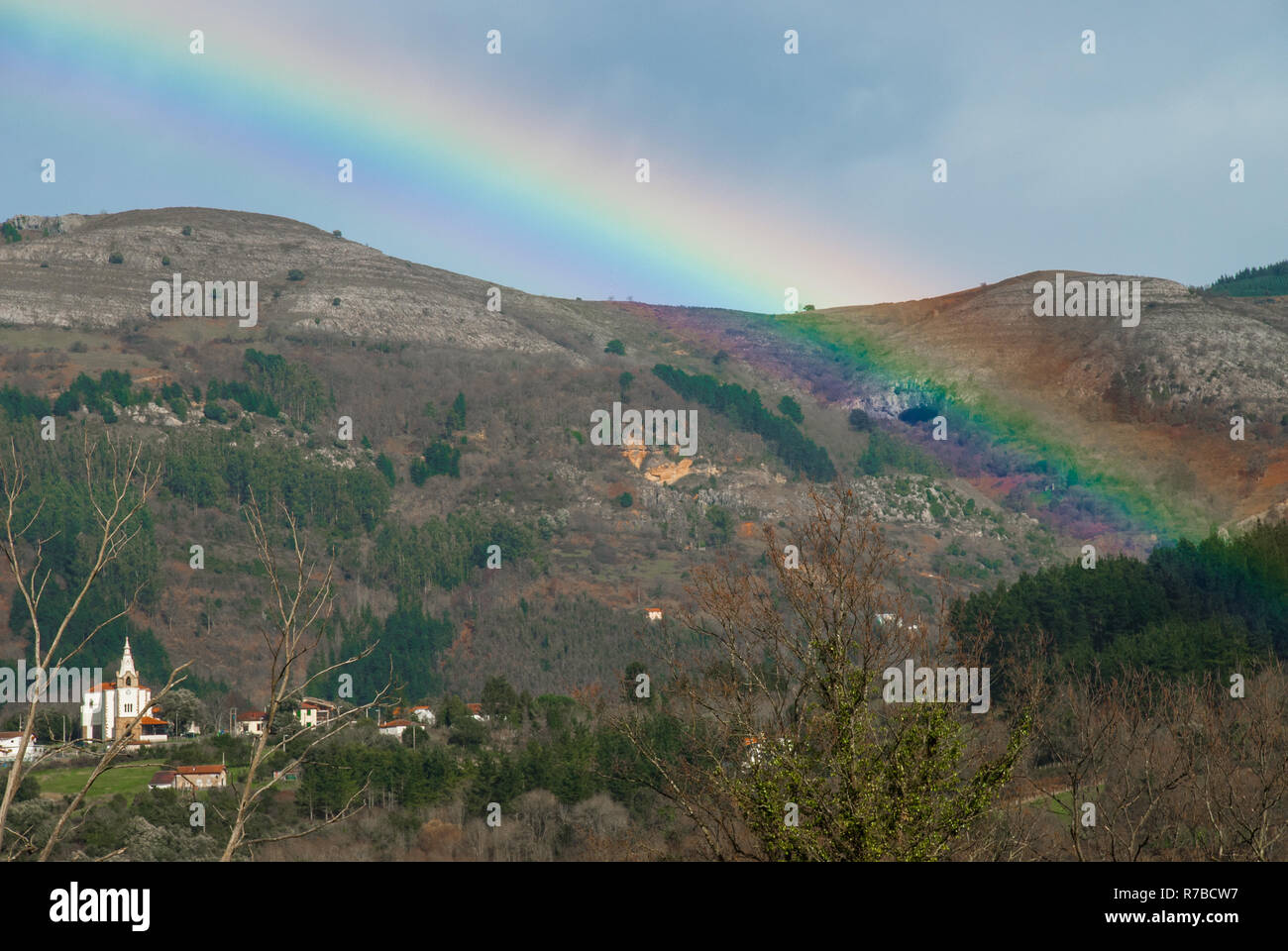 San Esteban de Galdames under the rainbow Stock Photo
