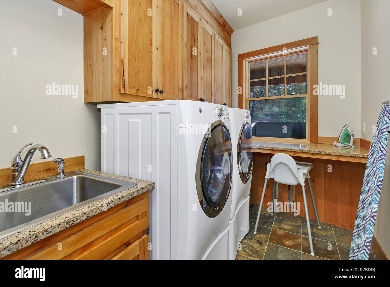 Laundry Room Interior With Sink And Cabinets Stock Photo