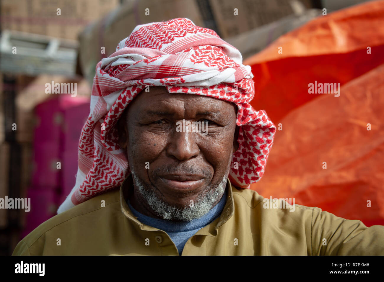Smiling Market trader wearing Ghutra headdress in a Dubai Souk, UAE