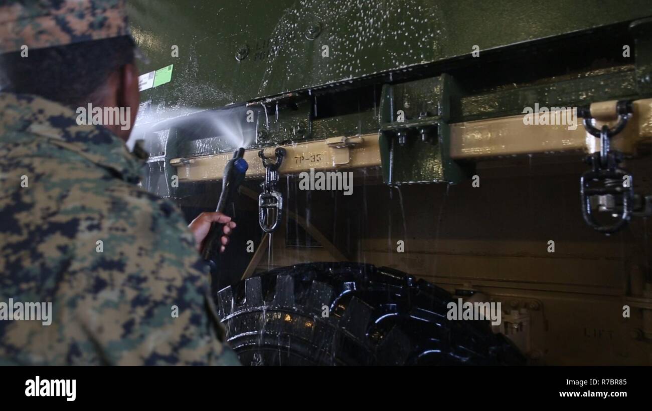 U.S. Marine Cpl. Coley Chestnut washes down a 7-ton truck during retrograde operations of Strategic Mobility Exercise 17 (STRATMOBEX) in Norway, May 9, 2017. Marines washed the equipment before returning it to the cave sites for storage. STRATMOBEX analyzes the responsiveness of all entities associated with the Marine Corps Prepositioning Program in Norway in order to set the conditions for future contingency operations. Stock Photo