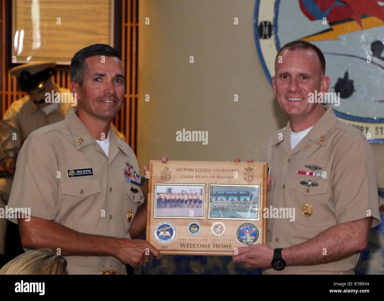 PENSACOLA, Fla. (May 9, 2017) Center for Information Warfare Training's Command Master Chief Mike Bates presents Master Chief Petty Officer of the Navy Steven Giordano with a plaque commemorating Giordano's return to Naval Air Station Pensacola Corry Station.  Giordano toured Pensacola-area commands during a two-day visit. Stock Photo