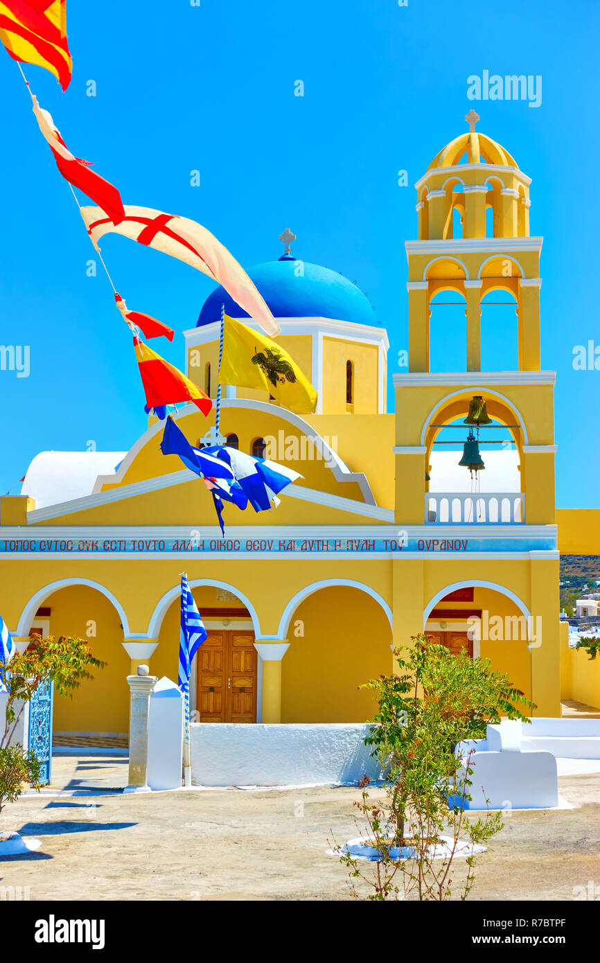 Vivid yellow St George Church (Ekklisia Agios Georgios) in Oia in Santorini island, Greece Stock Photo