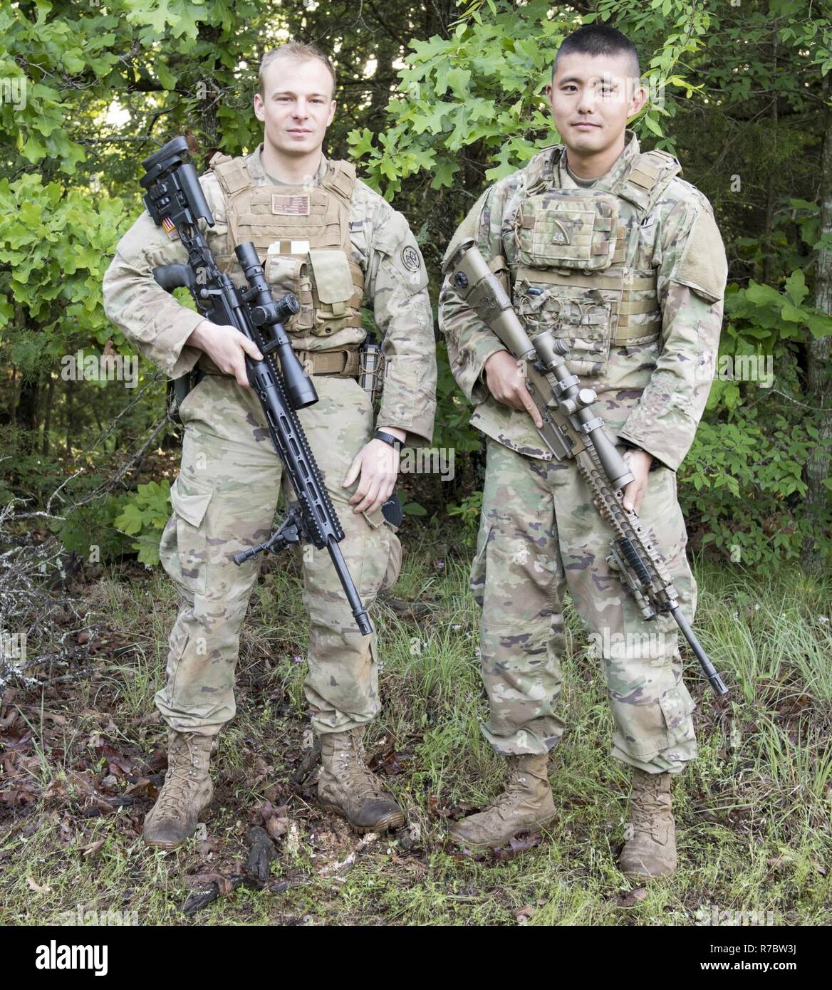 Team New York -- Sgt. David Peters, 2nd Squadron 101st Cavalry; and Staff Sgt. Masami Yamakado, 1st Battalion 69th Infantry-- pose   for a team photo at the 26th Winston P. Wilson Sniper Championship at Ft. Chaffee Joint Maneuver Training Center, Ark. on April 27, 2017. On this day of the competition contenders take their final shot down range. Stock Photo