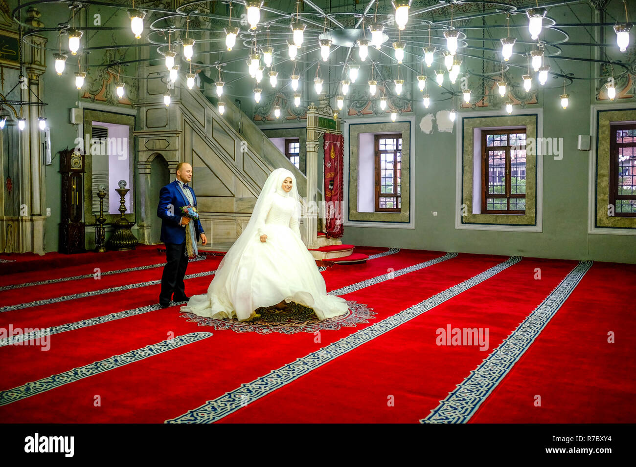 Bride and groom leaving the mosque after photoshoot Stock Photo