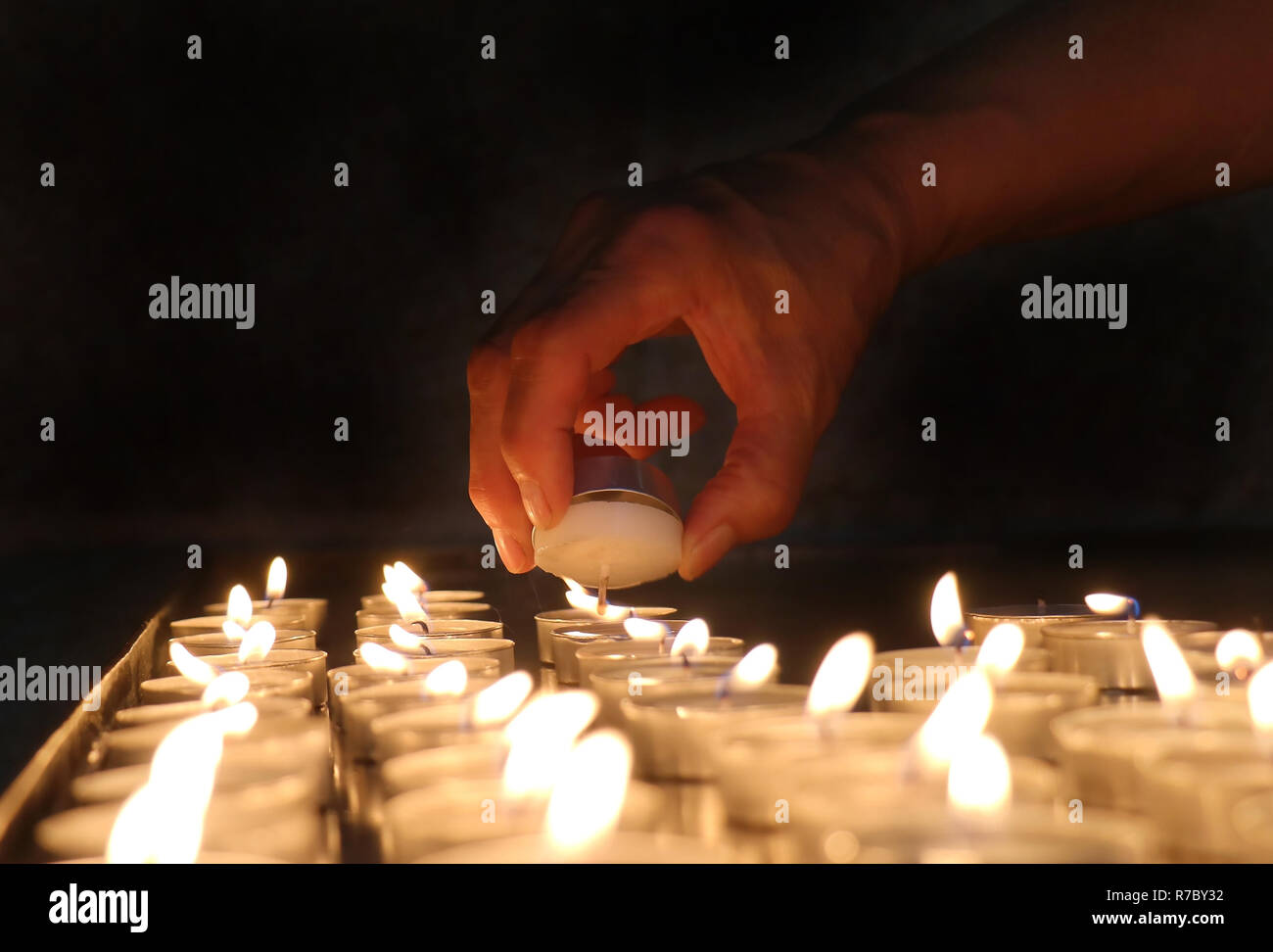 Lighting church candles Stock Photo - Alamy