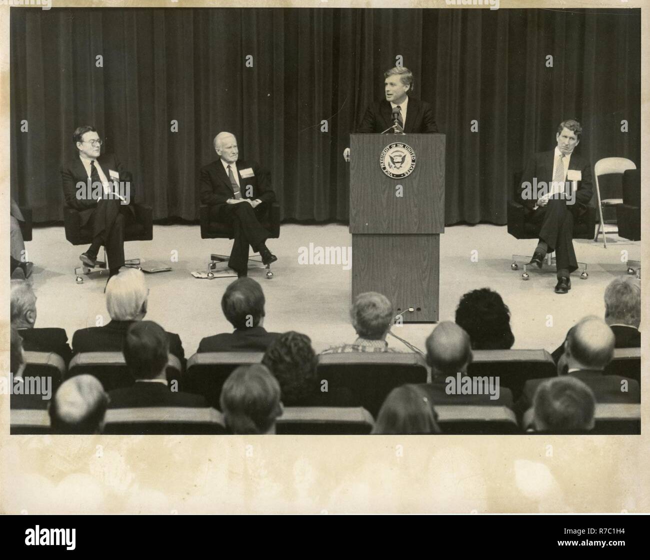 THERE IS A MAN AT THE PODIUM GIVING A SPEECH TO A GROUP OF MEN AND ...