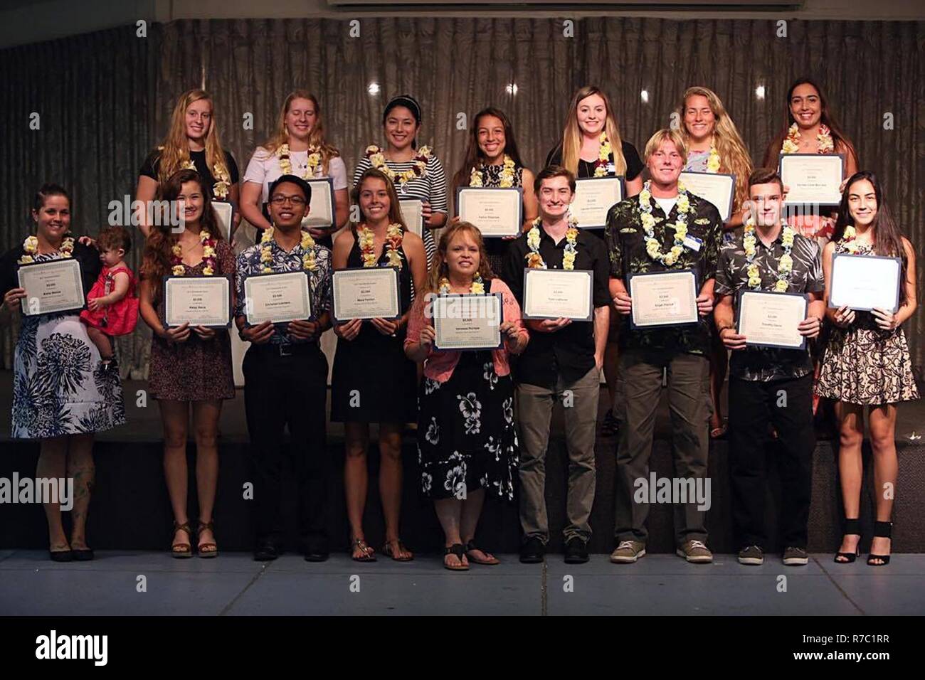 Scholarship recipients pose at the Hickam Officers’ Spouses’ Club Scholarship Awards Dinner on Hickam Field, Hawaii, May 9, 2017. Each year, the HOSC awards multiple grants and scholarships to military family members to help further their education. This year $59,500 was awarded to 17 individuals, and will be used at accredited trade schools, two-to-four year colleges, and universities, to include masters and doctorate-level programs. Stock Photo