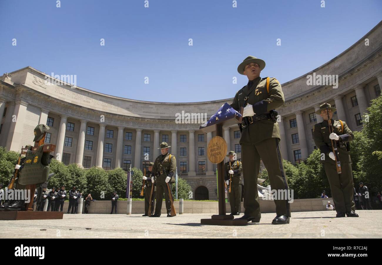 Members of the U.S. Border Patrol Honor Guard perform for families of fallen officers during the U.S. Customs and Border Protection's Valor Memorial and Wreath Laying Ceremony held in the Woodrow Wilson Plaza of the Ronald Reagan Building in Washington, D.C., May 16, 2017. U.S. Customs and Border Protection Stock Photo