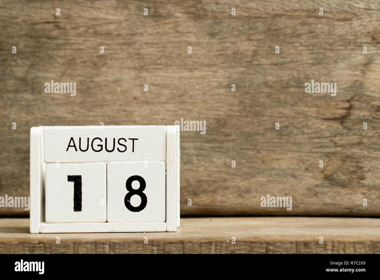 White block calendar present date 18 and month August on wood background Stock Photo