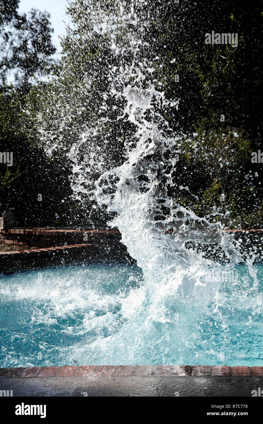 large cannonball splash in a swimming pool Stock Photo