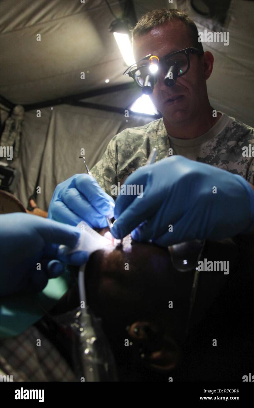 U.S. Army Maj. Aaron Taff, attached to the Wyoming National Guard Medical Detachment, sets a filling during a medical readiness event held in San Ignacio, Belize, May 08, 2017. This is the second of three medical events that are scheduled to take place during Beyond the Horizon 2017. BTH 2017 is a U.S. Southern Command-sponsored, Army South-led exercise designed to provide humanitarian and engineering services to communities in need, demonstrating U.S. support for Belize. Stock Photo