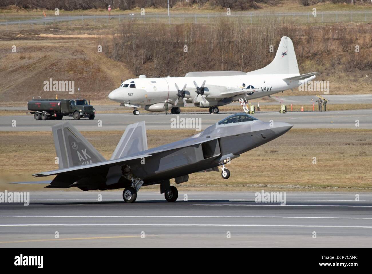 JOINT BASE ELMENDORF-RICHARDSON, Alaska – A U.S. Air Force F-22 Raptor lands May 5, 2017, in support of Exercise Northern Edge 2017. In the background is a U.S. Navy P-3 Orion. Northern Edge is Alaska’s largest and premier joint training exercise designed to practice operations, techniques and procedures, as well as enhance interoperability among the services. Thousands of participants from all the services—Airmen, Soldiers, Sailors, Marines and Coast Guard personnel from active duty, Reserve and National Guard units—are involved. Stock Photo