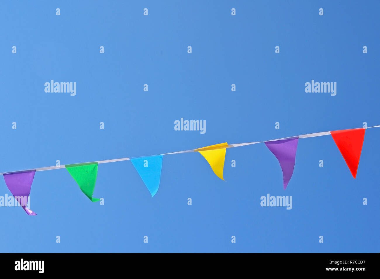 Colorful Flag Ropes Rope with colored flags hanging on a blue sky background Stock Photo ...
